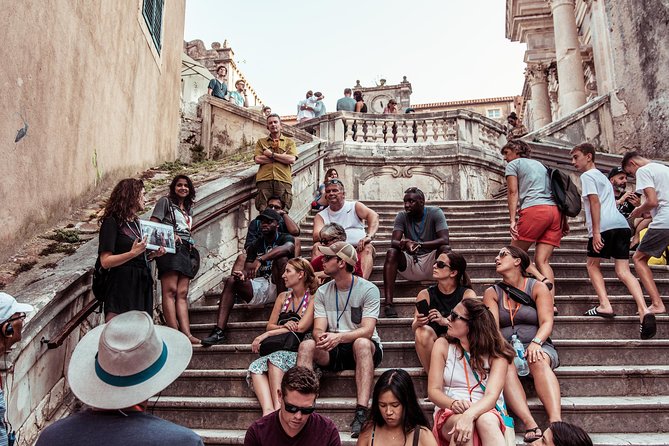 Dubrovnik: Game of Thrones Walking Tour - Getting started at Dubrovnik Walks, orange umbrella and clear headsets